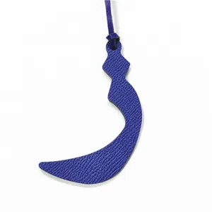 Blue leather Arabic letter bag charm detail view, elegant purse pendant accessory.