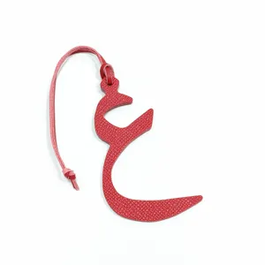 Red leather Arabic letter bag charm detail, stylish mini pendant accessory for purse.