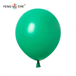 Green latex balloon close-up shot, inflatable party decoration detail view, smooth surface.