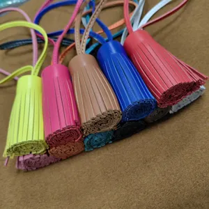 Colorful genuine leather tassel charm for bag and car rearview mirror decoration.