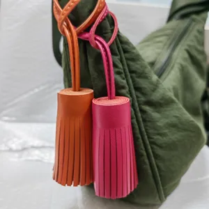 Leather tassel bag charm detail shot, stylish handbag accessory with vibrant colors for daily use.