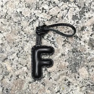Black leather letter F bag charm keychain, stylish initial purse pendant and car accessory.