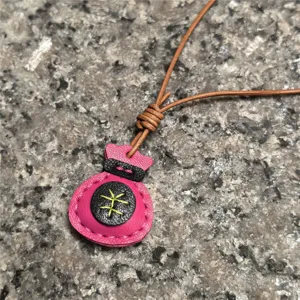 Handmade genuine leather lucky bag pendant detail, showcasing fine stitching and stylish texture.