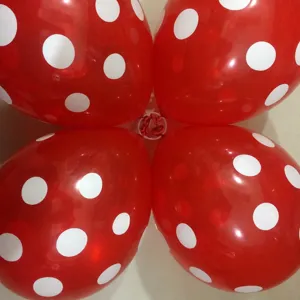 Red polka dot balloons with white plastic arch clips for party and event decoration.