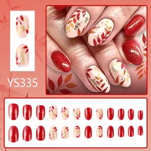 Detailed view of autumn short almond press-on nails featuring sparkling glitter and leaf art.
