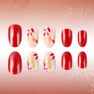 Autumn short almond press-on false nails with sparkly red glitter and gold leaf art.