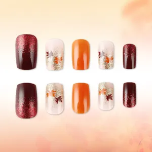 Autumn press on nails with glitter and maple leaf design, stylish glossy fake nails for women.