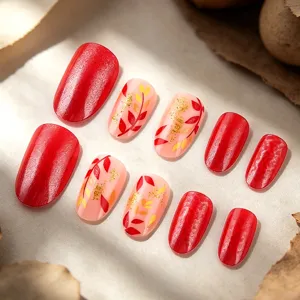 Detailed showcase of autumn press-on nails with red glitter and lovely leaf pattern designs.