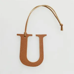 Leather letter U bag charm initial keychain for women, stylish handbag hanging accessory.