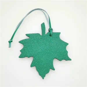 Green leather maple leaf bag charm and car pendant accessory, stylish leather accessory.