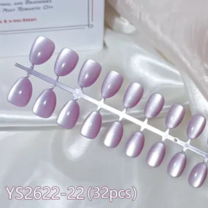 Detail view of 32pcs short round aurora cat eye press-on nail tips in soft purple hue.
