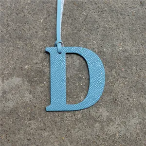 Blue leather letter D bag charm with strap, elegant accessory for handbags and backpacks.
