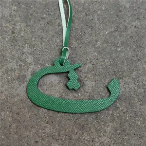 Green leather Arabic letter bag charm, stylish purse accessory and car hanging ornament.