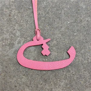 Pink leather Arabic letter bag charm detail view, stylish accessory for purses and car decor.
