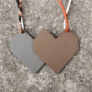 Chic leather bag charm set with diamond and heart shapes, paired with colorful printed twilly.