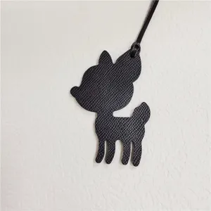 Black leather deer bag charm detail, cute animal pendant accessory for women handbags.