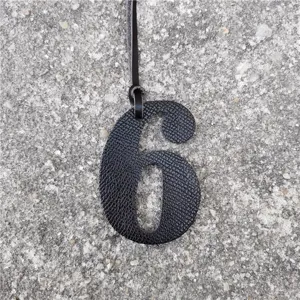 Detailansicht des schwarzen Nummer 6 Leder Textur Taschenanhanger fur DIY Zubehor.