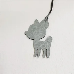 Grey leather deer bag charm close-up detail, cute animal pendant showcasing fine craftsmanship.