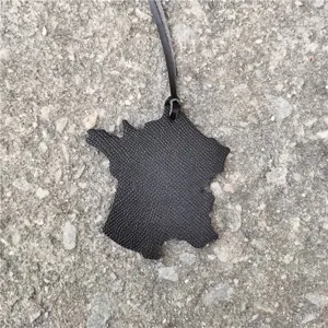 Stylish black leather France map shape bag pendant and car hanging ornament detail view.