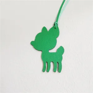 Green leather deer bag charm detail view, cute animal pendant accessory for women handbags.