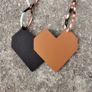 Leather heart bag charm with twilly scarf strap, double-sided color pendant accessory.