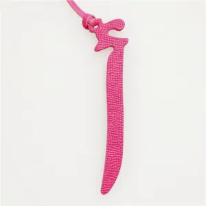 Pink leather decorative charm detail, stylish alphabet bag pendant and car keychain accessory.