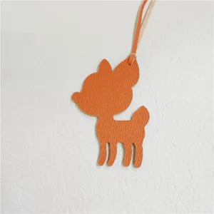 Orange leather deer bag charm, cute fawn keychain pendant, luxury style handbag accessory.