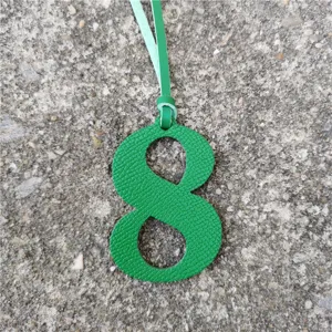 Green leather number 8 bag charm pendant DIY accessory for stylish handbag decoration.