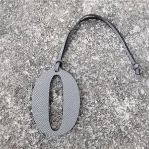 Gray leather number zero bag charm with strap, luxury style diy accessory detail.