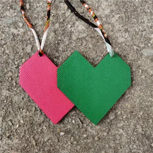 Two-tone leather heart bag charm with printed ribbon strap, cute stylish handbag pendant.