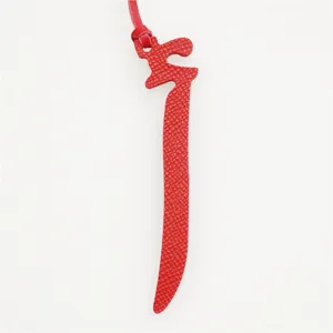 Red leather Arabic letter bag charm, elegant keychain accessory for women handbag detail view.