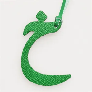 Green leather Arabic letter bag charm, elegant luxury style handbag pendant and key chain accessory.