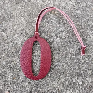 Number 0 leather bag charm, burgundy litchi grain DIY pendant with pink and red leather straps.