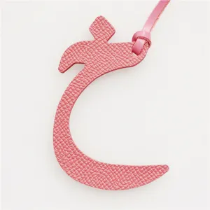 Pink leather Arabic letter bag charm pendant, stylish keychain accessory for handbags and car keys.