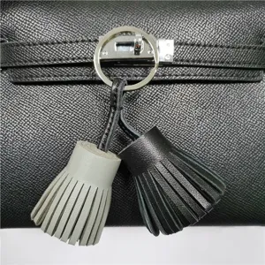 Dual color leather tassel bag charm key chain stylish accessory for handbags and car keys.