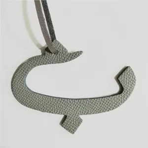 Gray leather Arabic letter bag charm variant. Stylish accessory for purses and car interior hanging.