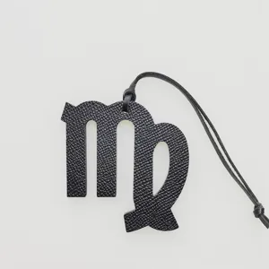 Black Virgo zodiac bag charm detail shot showing premium leather texture and hanging cord.