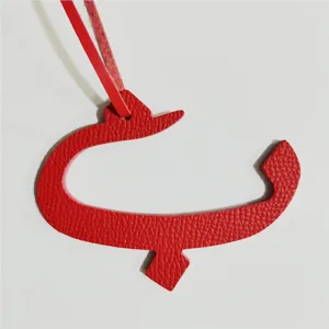Red leather Arabic letter bag charm, stylish handbag accessory and unique pendant gift for women.