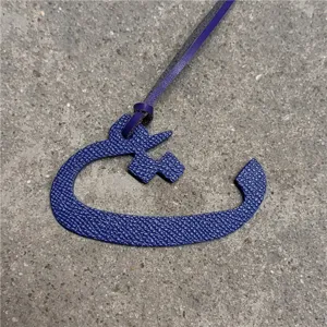 Blue leather Arabic letter bag charm pendant, stylish accessory for purses and handbags.