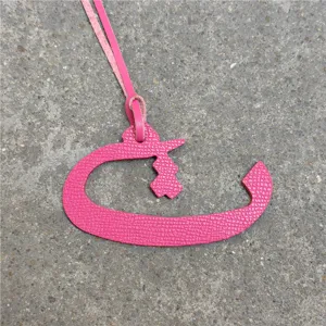 Pink leather Arabic letter bag charm detail view, stylish handbag accessory or car hanging ornament.