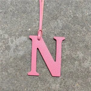 Pink leather letter N bag charm with strap, cute handbag pendant accessory for women.