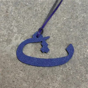 Purple leather Arabic letter bag charm, elegant handbag pendant and chic car hanging accessory.