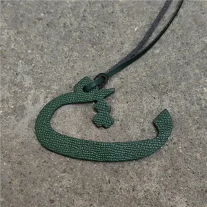 Green leather Arabic letter bag charm, stylish car hanging ornament and exquisite handbag accessory.