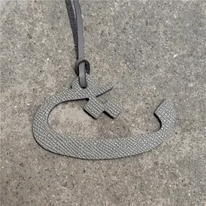 Gray leather Arabic letter bag charm stylish handbag accessory pendant for daily use.