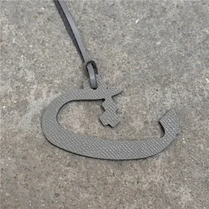 Grey textured leather Arabic letter bag charm and car hanging ornament detail view.