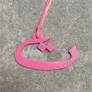 Pink leather Arabic letter bag charm, chic luxury style handbag pendant accessory for women.