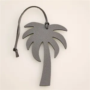 Grey leather palm tree bag charm and car hanging ornament, stylish daily accessory.