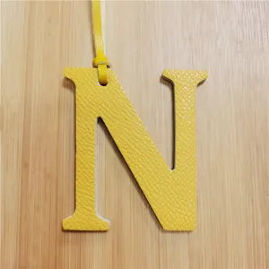 Yellow leather letter N bag charm for women, stylish initial purse pendant and handbag accessory.