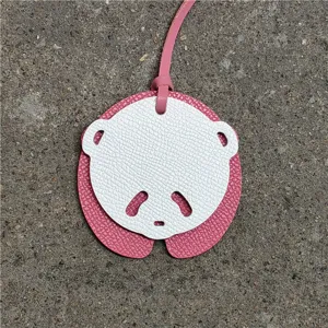 Charmant pendentif sac panda en cuir rose et blanc détail, accessoire de mode pour femme.