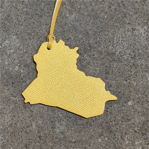 Yellow leather Iraq map bag charm pendant stylish accessory for handbags and daily decor.